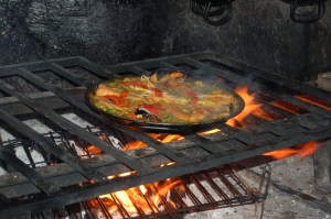 Delicious aromas of seafood paella and wood smoke