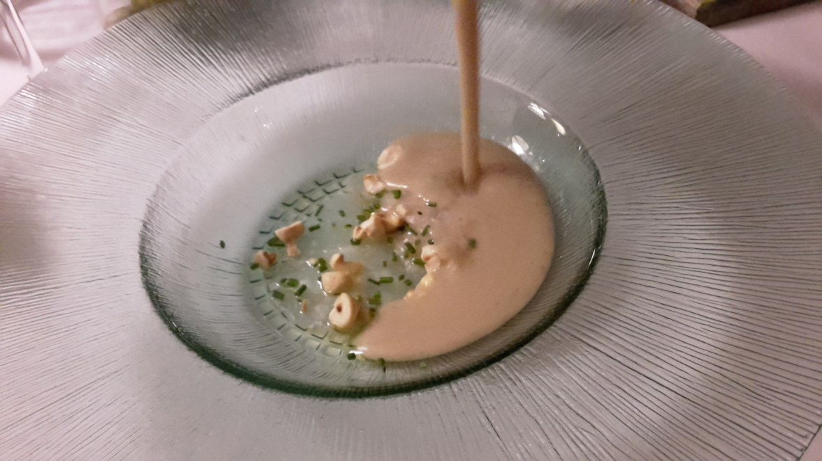 Soup being poured at table