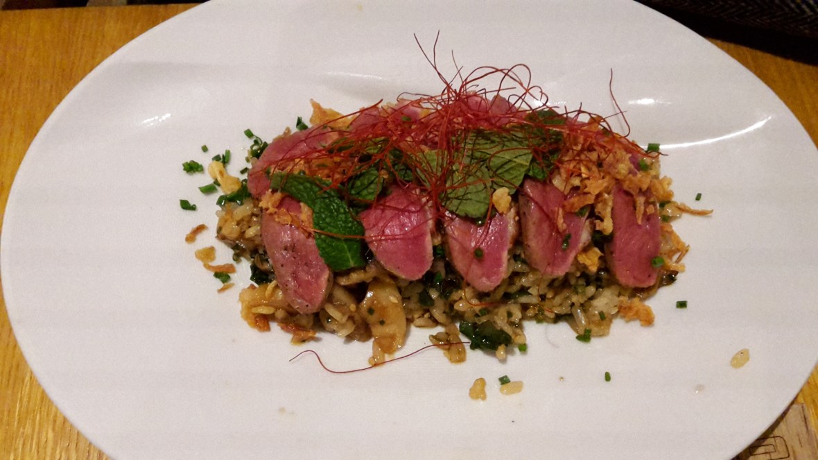Main course on lunch menu of Japanese crispy rice with duck breast